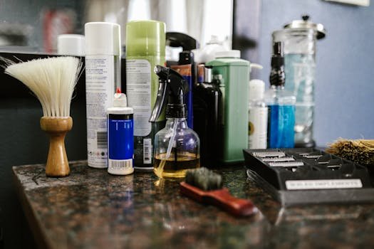 Collection of grooming products and tools on a barbershop countertop.